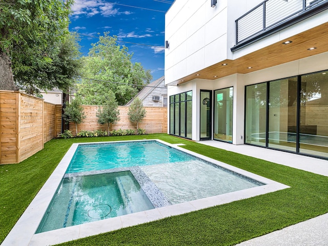 view of swimming pool with an in ground hot tub and a lawn