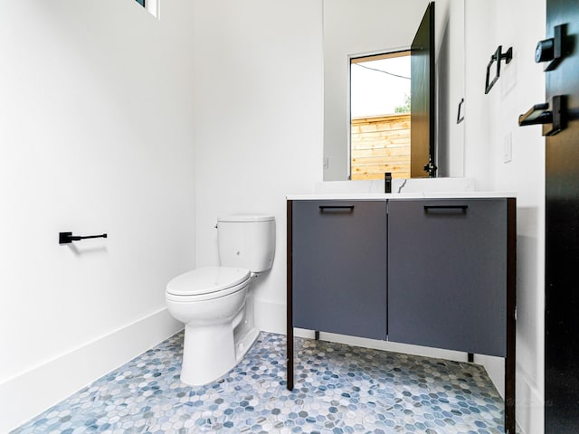 bathroom featuring plenty of natural light, vanity, and toilet