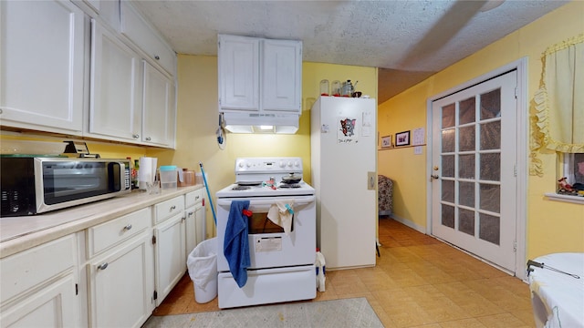 kitchen featuring a textured ceiling, white cabinetry, and white appliances