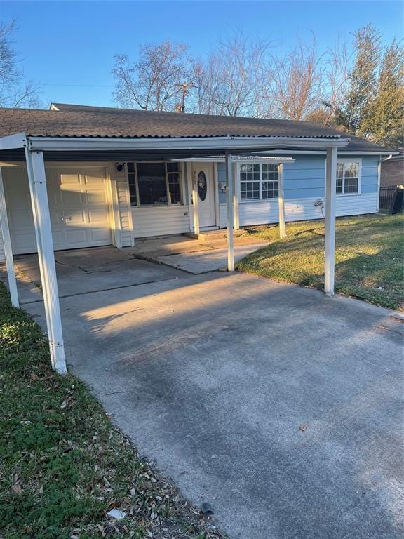 ranch-style house featuring a carport and a front lawn