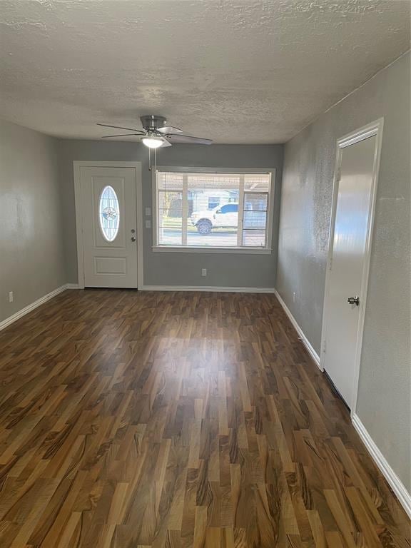 entrance foyer featuring ceiling fan, dark hardwood / wood-style floors, and a textured ceiling