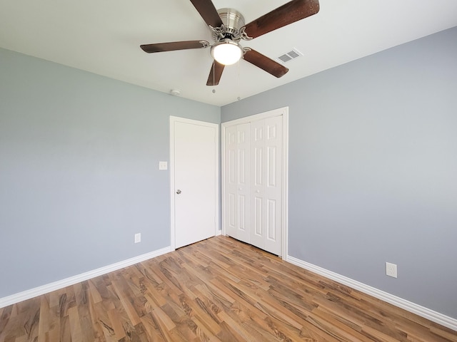 unfurnished room with ceiling fan and light hardwood / wood-style floors