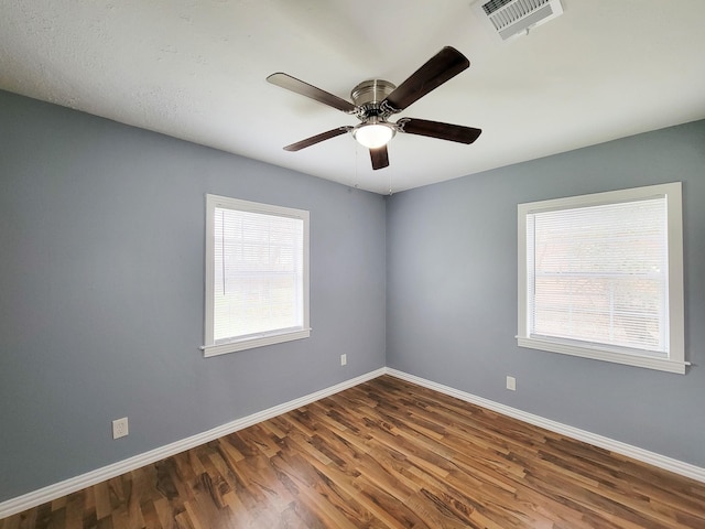 spare room featuring hardwood / wood-style flooring and ceiling fan