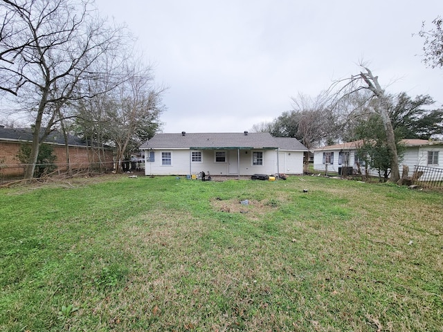 rear view of house with a lawn