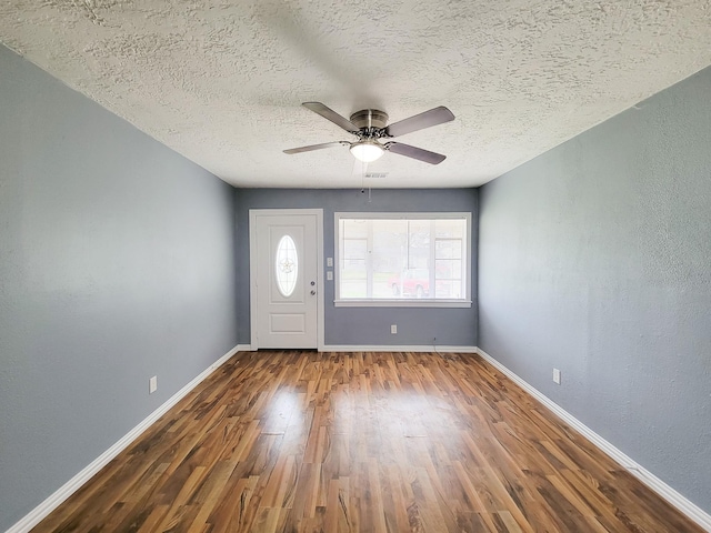 foyer with hardwood / wood-style flooring, ceiling fan, and a textured ceiling