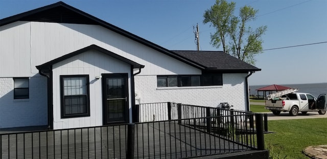 view of side of home with a lawn