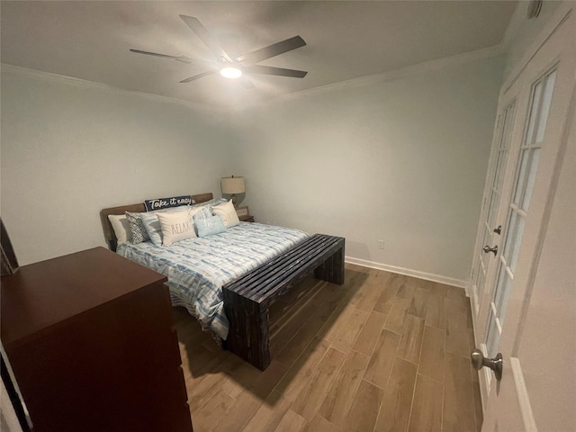 bedroom with ceiling fan, light hardwood / wood-style floors, and ornamental molding