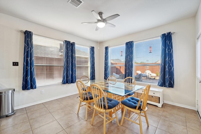 tiled dining space with ceiling fan