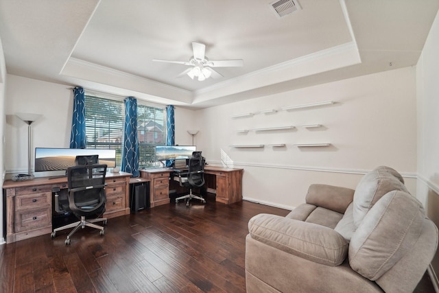 home office featuring a raised ceiling, ceiling fan, and dark hardwood / wood-style flooring