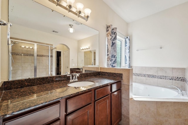 bathroom with vanity and independent shower and bath