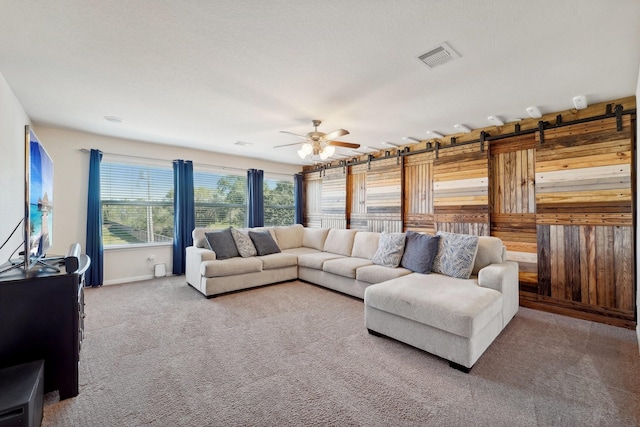 carpeted living room featuring ceiling fan