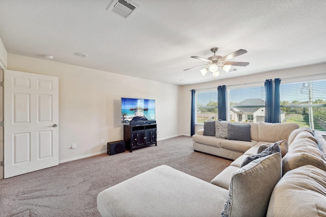 carpeted living room featuring ceiling fan