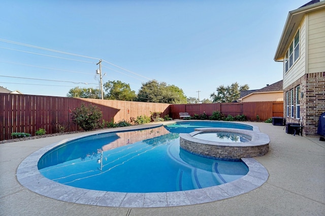 view of pool featuring an in ground hot tub and a patio