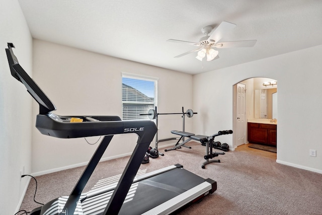 workout room featuring ceiling fan and light colored carpet