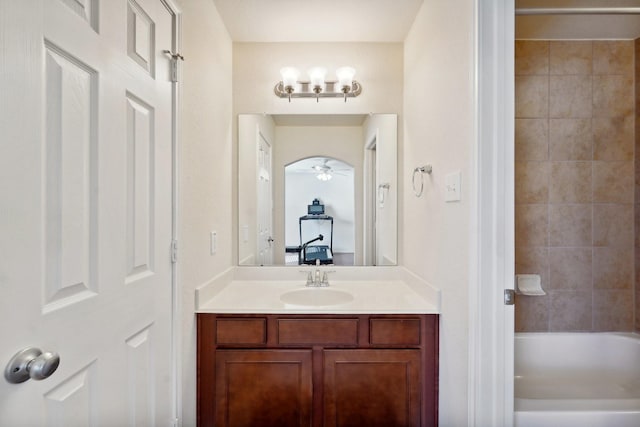 bathroom featuring vanity, tiled shower / bath combo, and ceiling fan