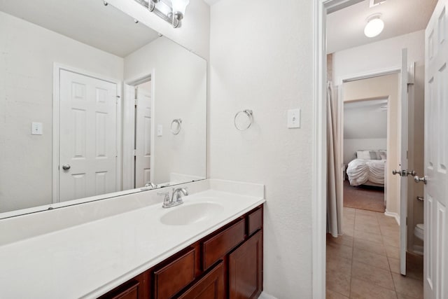 bathroom featuring tile patterned floors, vanity, and toilet