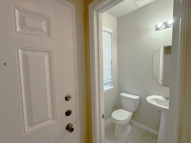 bathroom featuring tile patterned flooring, toilet, and sink