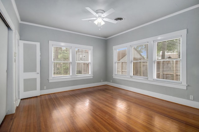 unfurnished room featuring ceiling fan, wood-type flooring, and crown molding