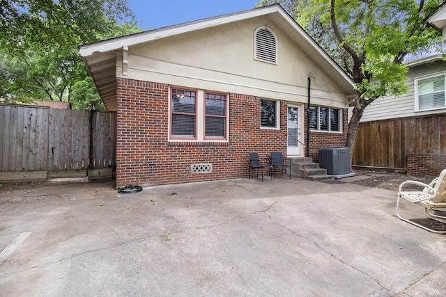 rear view of house with a patio and central AC unit