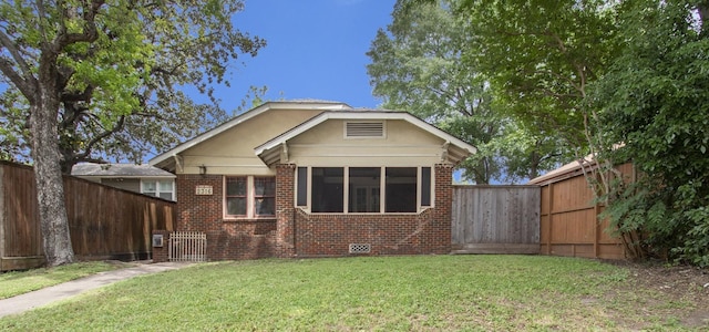 rear view of property featuring a lawn