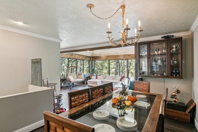 dining area featuring a textured ceiling, a notable chandelier, crown molding, and dark wood-type flooring