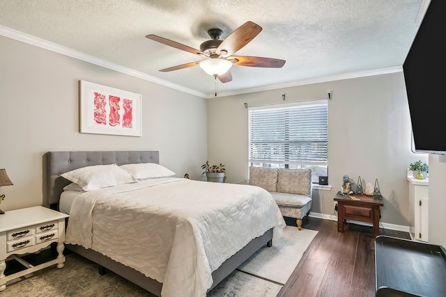 bedroom featuring baseboards, wood finished floors, ornamental molding, and a textured ceiling