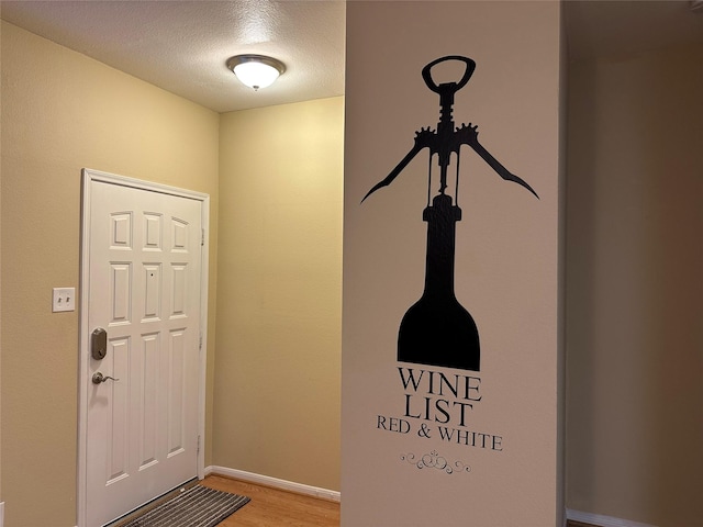 entryway featuring a textured ceiling and hardwood / wood-style flooring