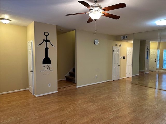 empty room with ceiling fan and wood-type flooring