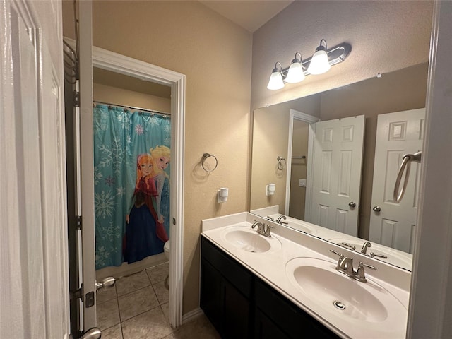 bathroom featuring toilet, vanity, and tile patterned floors