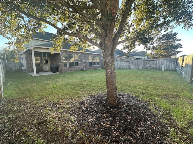 view of yard featuring a fenced backyard and a patio