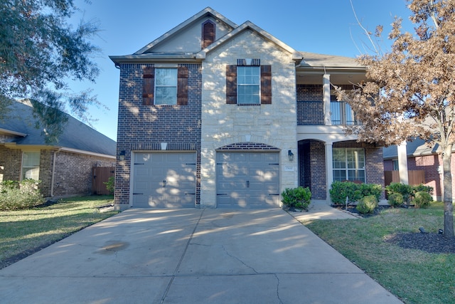 traditional home featuring a balcony, driveway, an attached garage, a front yard, and brick siding
