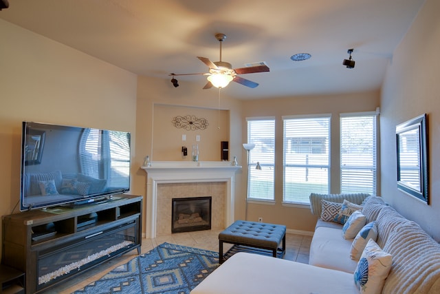 living room with ceiling fan, light tile patterned floors, and a fireplace