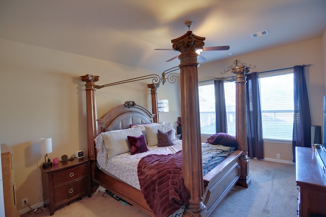 bedroom with light carpet, baseboards, visible vents, and ceiling fan