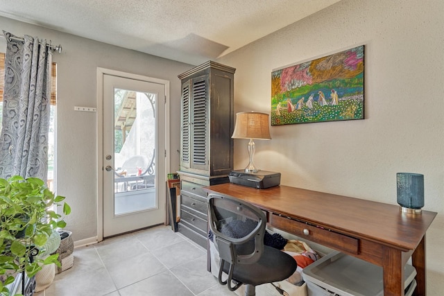 office area with light tile patterned floors and a textured ceiling