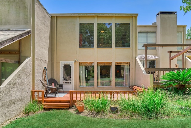 rear view of house with a wooden deck