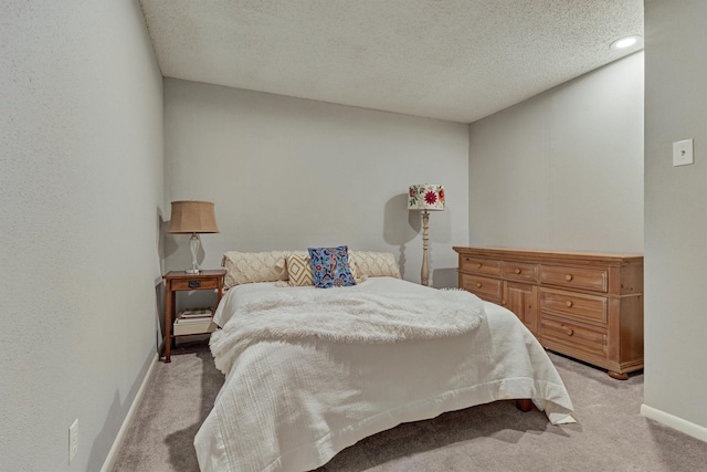 carpeted bedroom featuring a textured ceiling