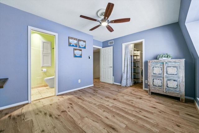 unfurnished bedroom with ensuite bathroom, ceiling fan, and light hardwood / wood-style floors