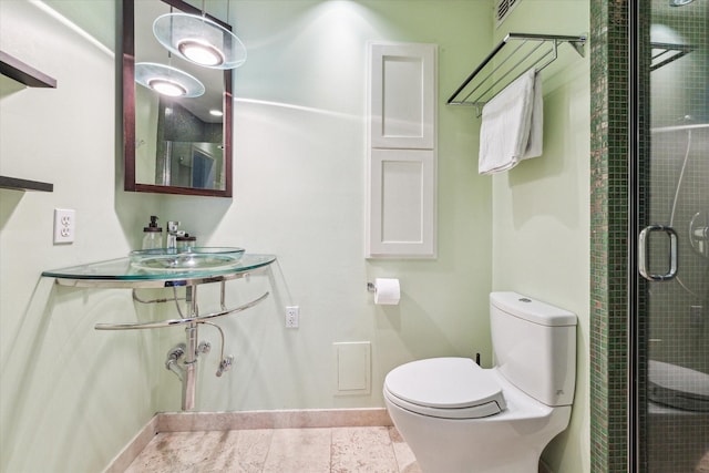 bathroom featuring tile patterned floors, toilet, and an enclosed shower