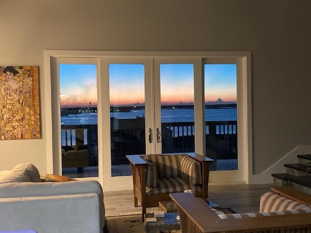 living room with hardwood / wood-style floors and a water view