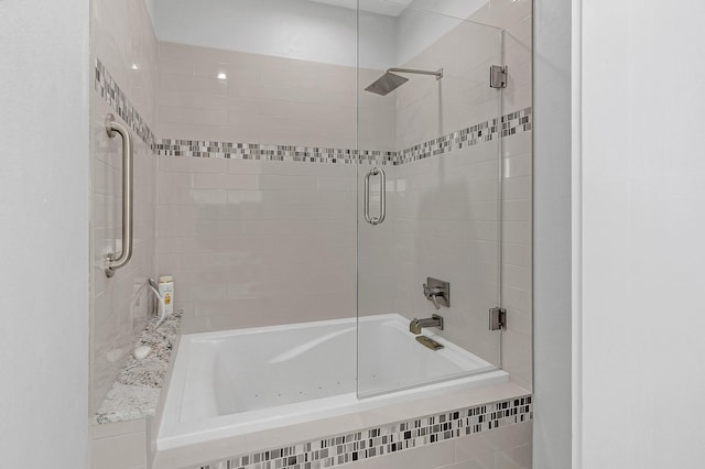 bathroom featuring shower / bath combination with glass door