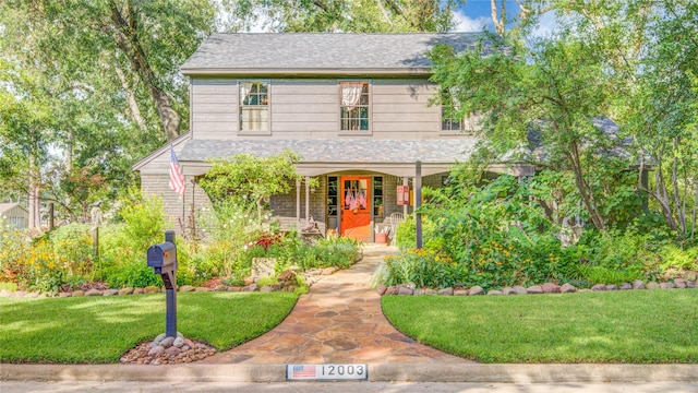 view of front of home with covered porch and a front yard