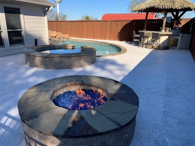 view of pool with a grill, an outdoor bar, a gazebo, an in ground hot tub, and a patio