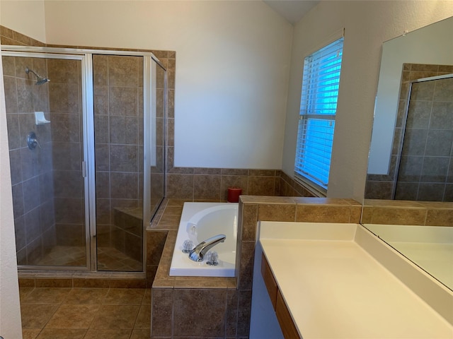 bathroom with tile patterned flooring, vanity, and plus walk in shower