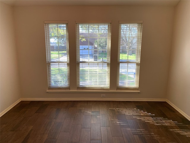 unfurnished room featuring dark wood-type flooring