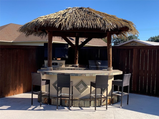 view of patio / terrace with a grill and a bar