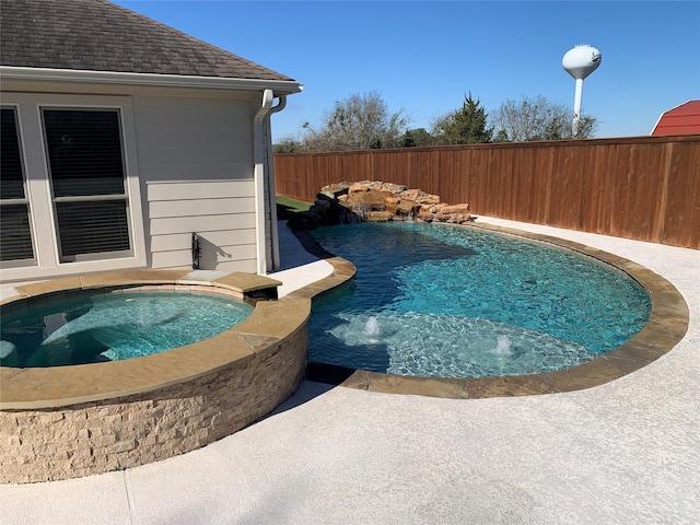 view of pool with an in ground hot tub and pool water feature