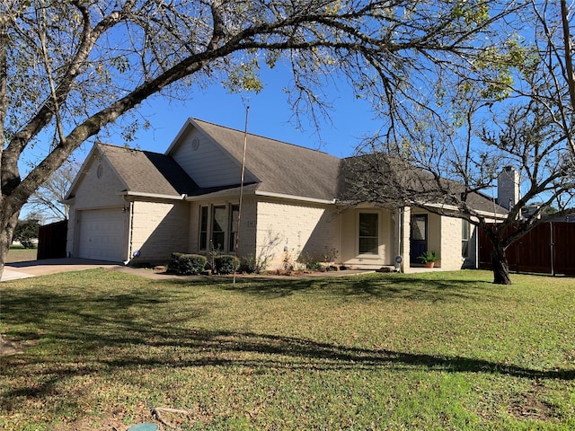 view of front of home with a front yard and a garage