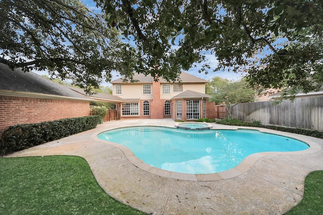 view of pool with an in ground hot tub and a patio