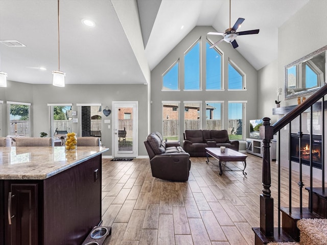 living room featuring high vaulted ceiling and ceiling fan