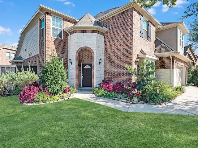 view of front of home featuring a front yard and a garage